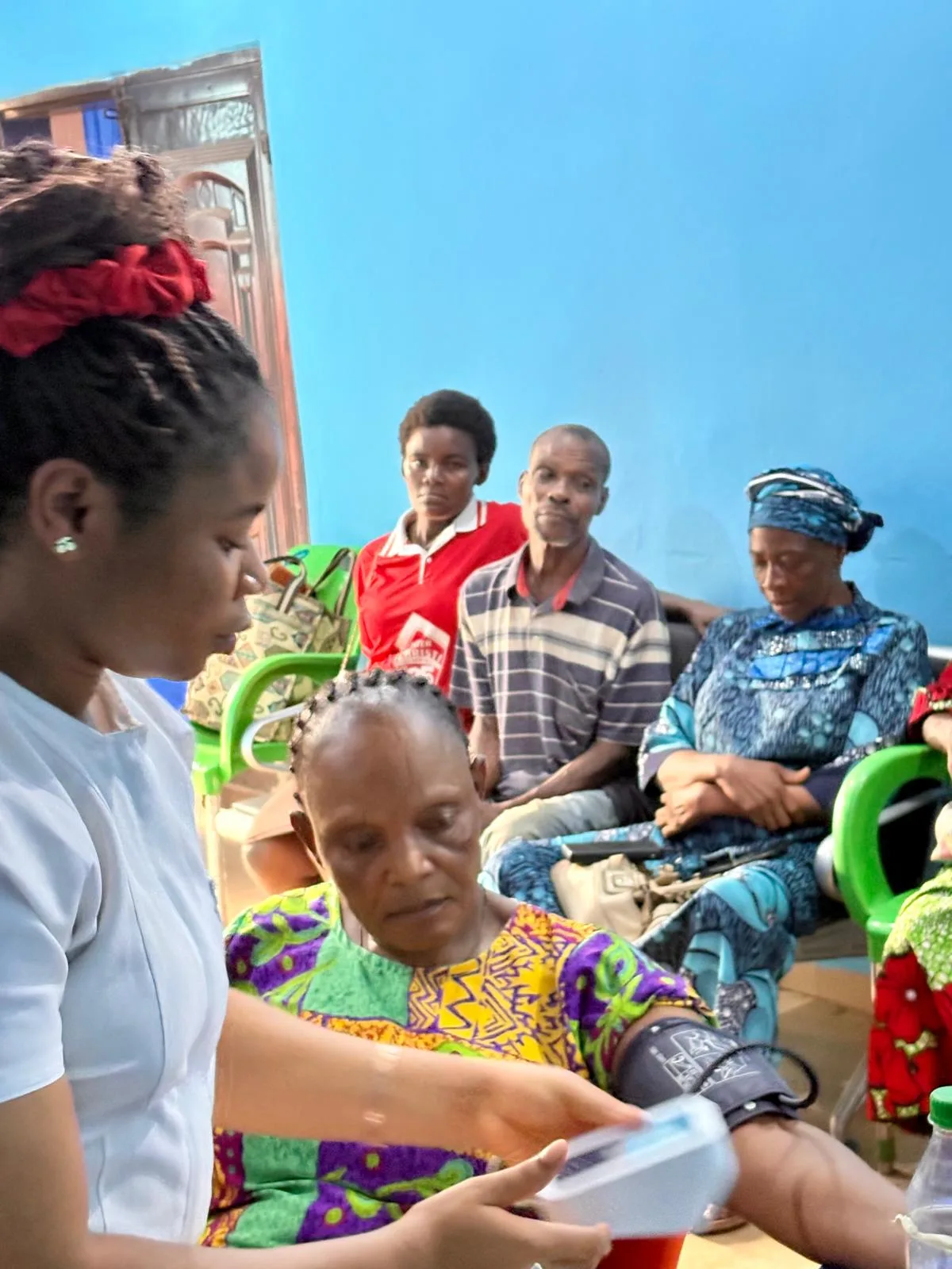 Nurse checking an elderly patient's blood pressure