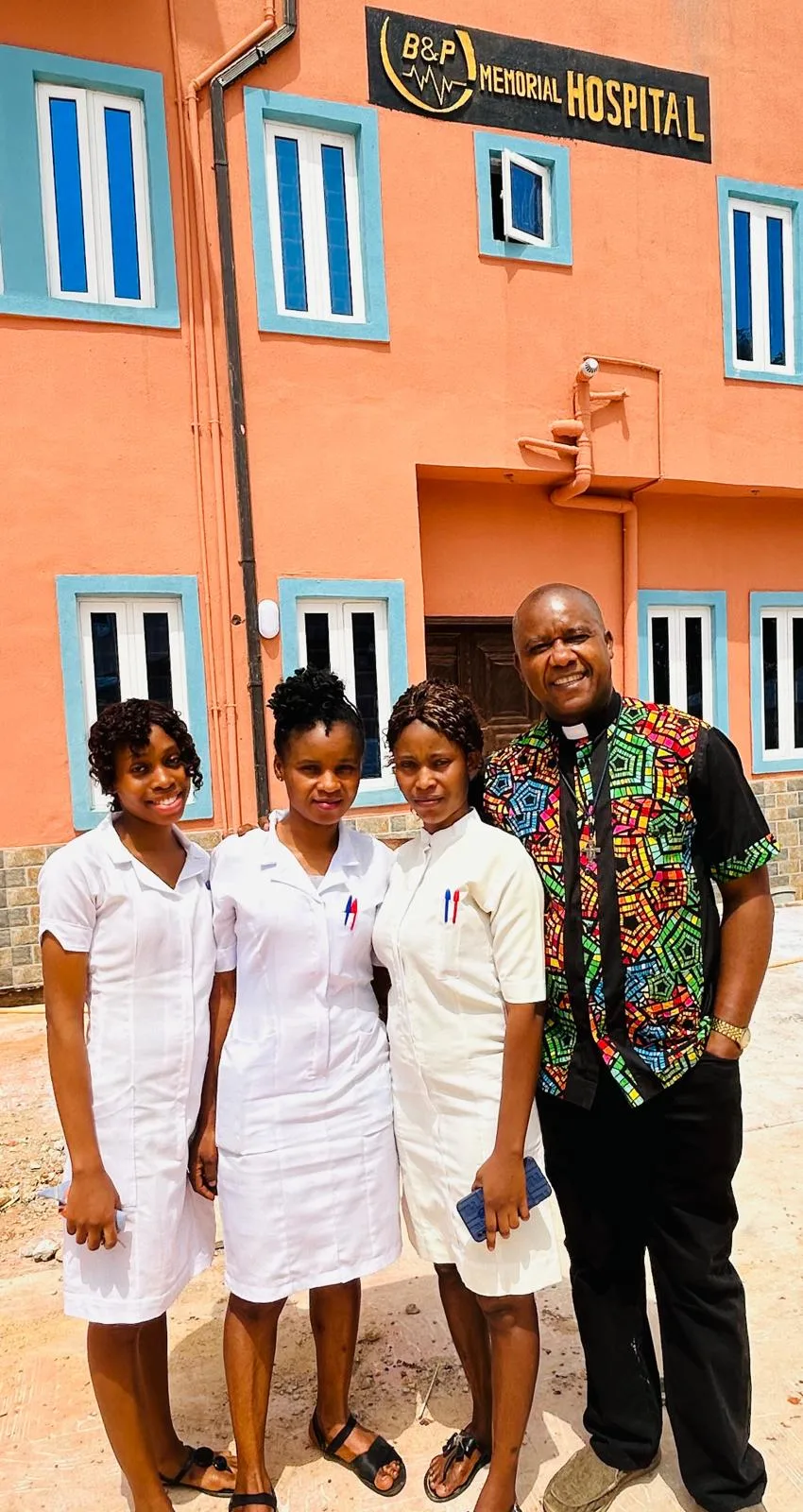 Hospital staff standing together at the hospital entrance