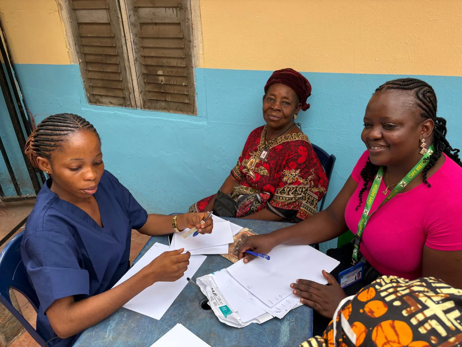 A member of the hospital team sitting with a patient at a desk